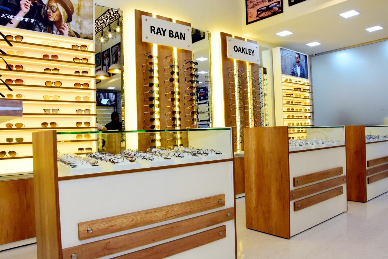 Showroom counters with prescription frames and branded sunglasses racks