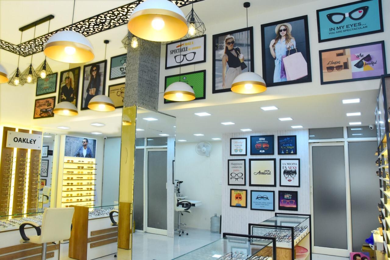 Interior of Shree Optics with designer lighting and framed eyewear art