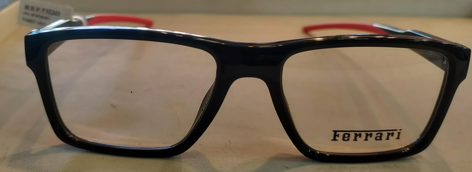 Glossy black sports eyeglass frame with red temples