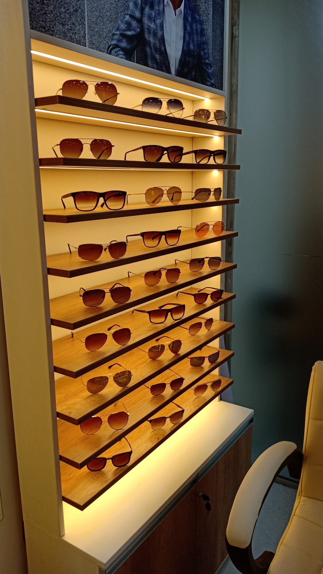 Backlit shelves of premium sunglasses at Shree Optics