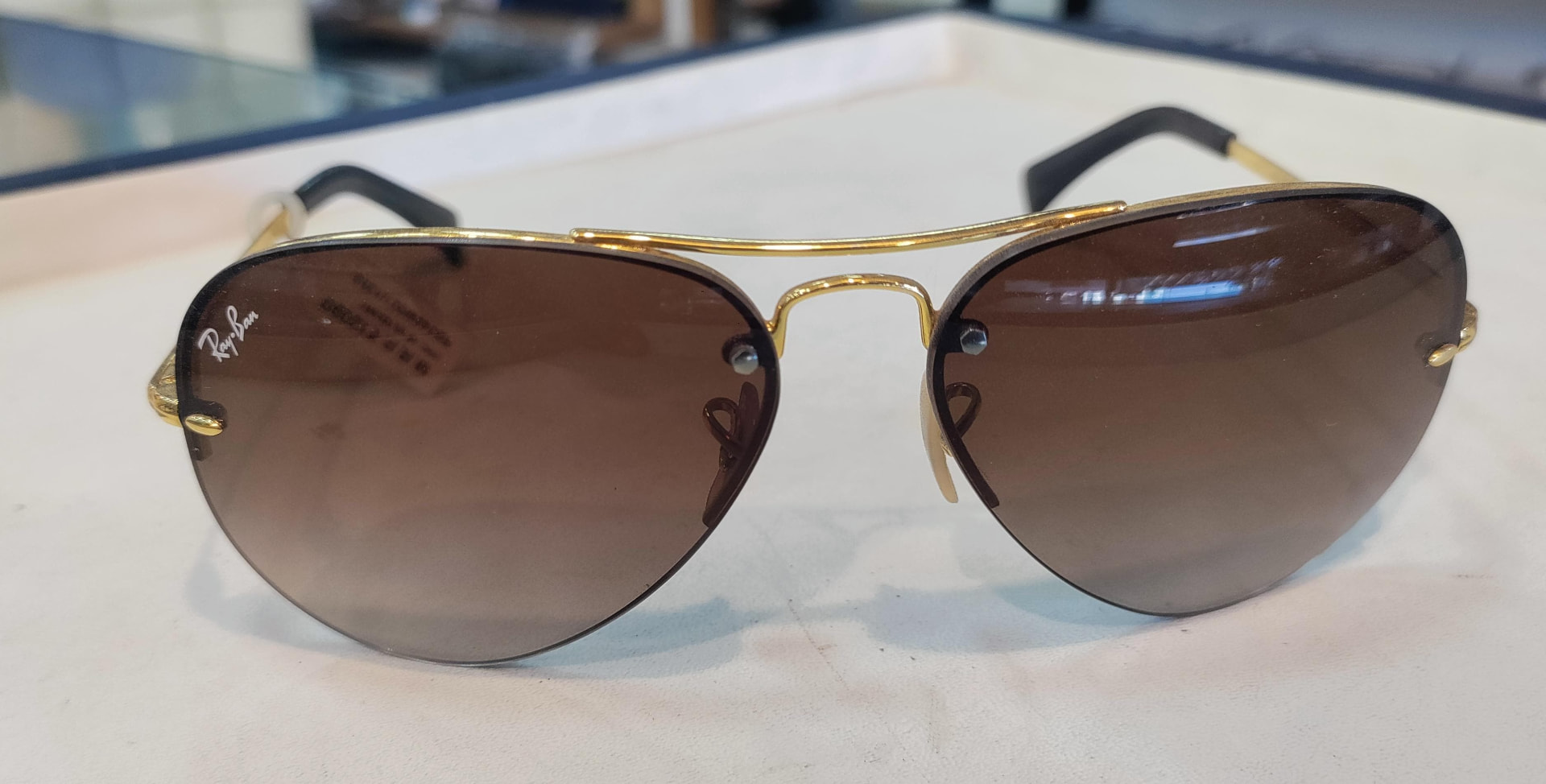 Gold rimless aviator sunglasses with gradient brown lenses
