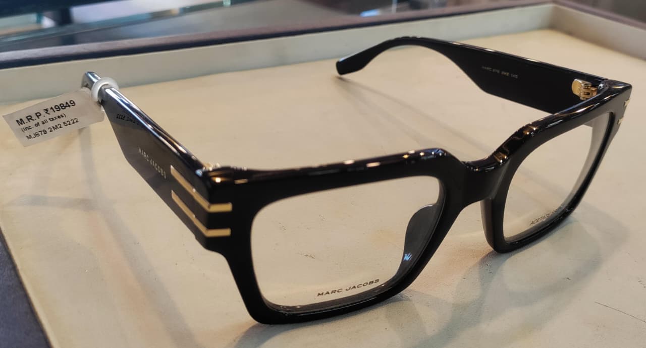 Side view of black acetate frame with gold accents