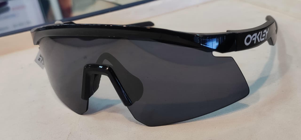 Angled view of black wrap-around sports sunglasses