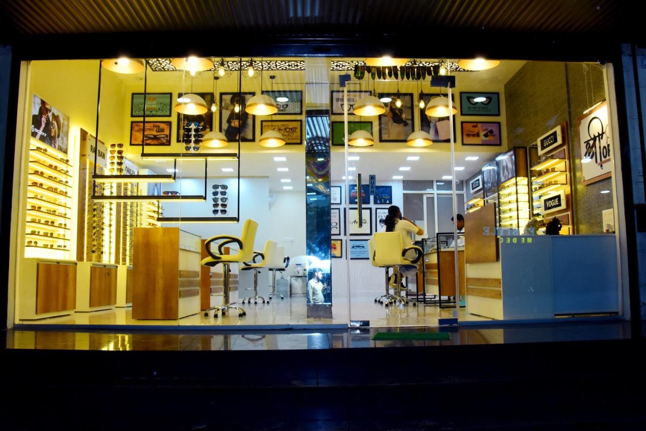 Shree Optics storefront illuminated at night at Parmar Square, Kharadi