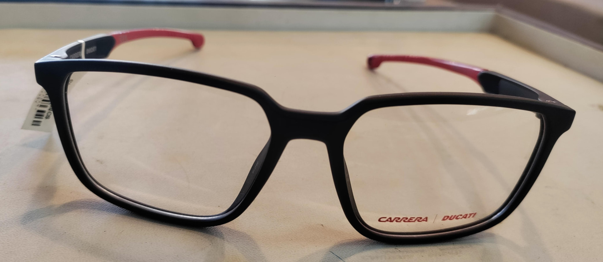Matte black eyeglass frame with red temple tips
