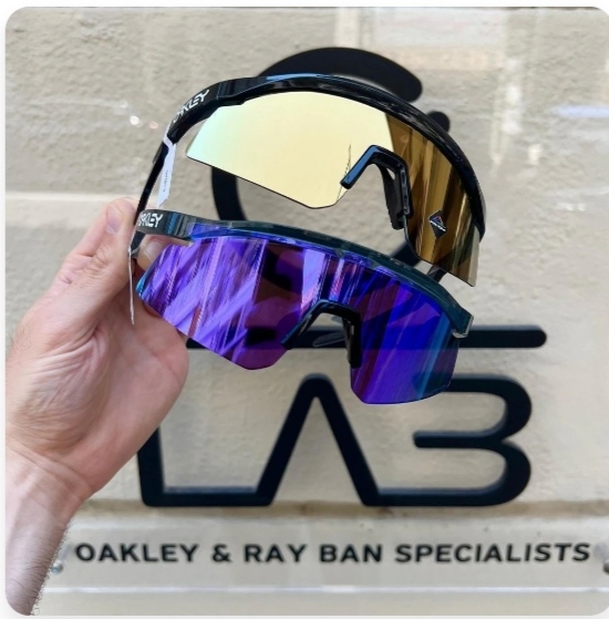 Oakley and Ray-Ban specialist sunglasses held in hand